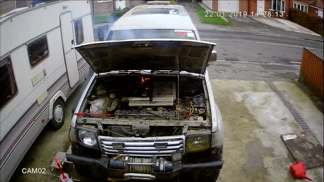 Man Rushes to Put out Fire Coming from Car