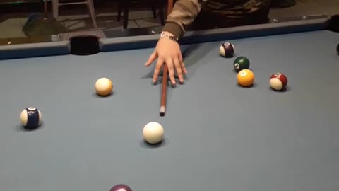 Camo shirt girl places cue ball then shoots it off table