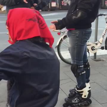 Group of men on skates on corner of street