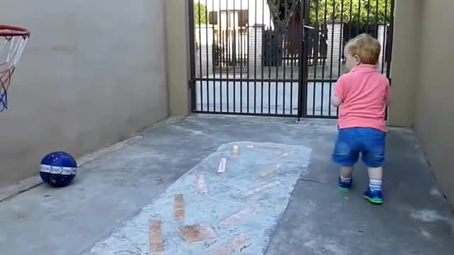 Baby playing basketball