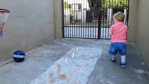 Baby playing basketball