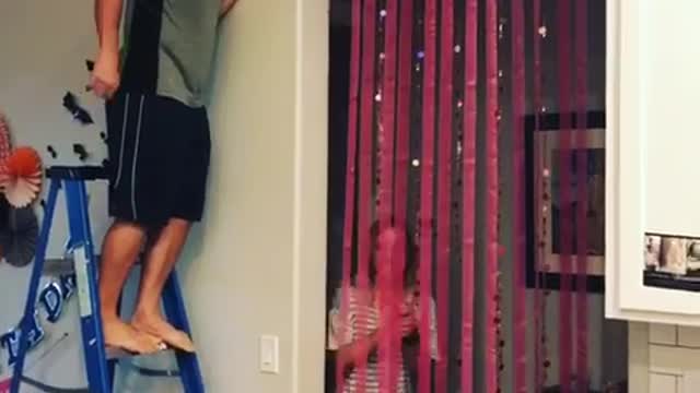 Guy blue ladder pops balloon scares girl