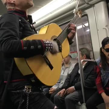 Mohawk guy sings spanish song on subway