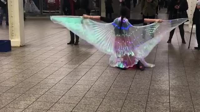 Woman colorful translucent wings dancing on floors