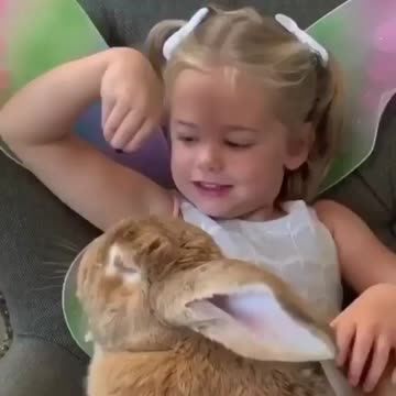 Toddler's are playing with beautiful bunny