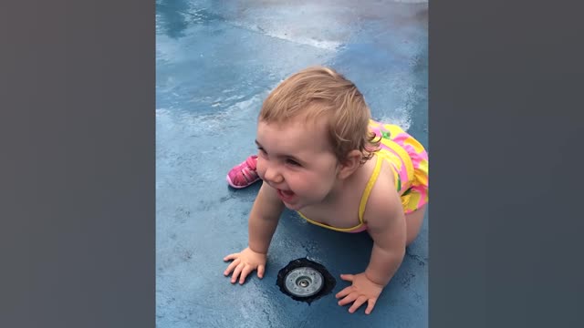 Funny baby playing with water