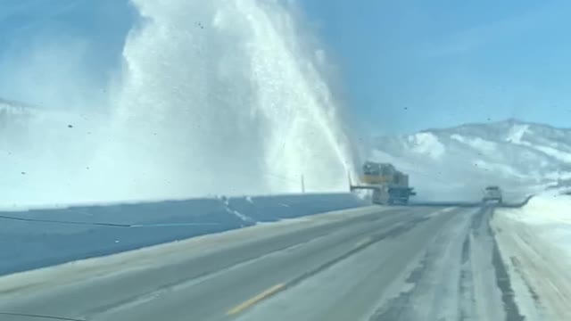 Snow Removal Machine Sending Snow Skyward