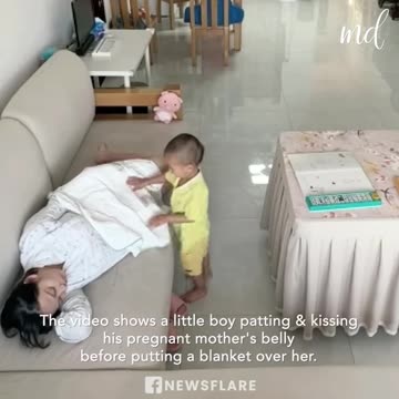 Toddler covers pregnant mother with blanket as she falls asleep
