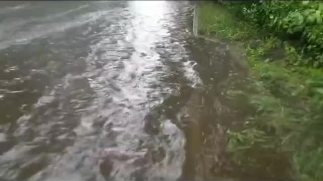 Unclogging the sewers to drain flooded street