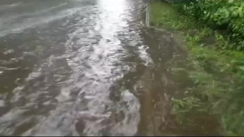 Unclogging the sewers to drain flooded street