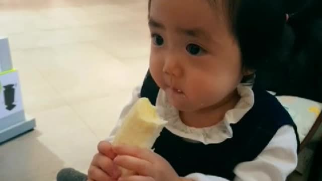 Baby eating banana