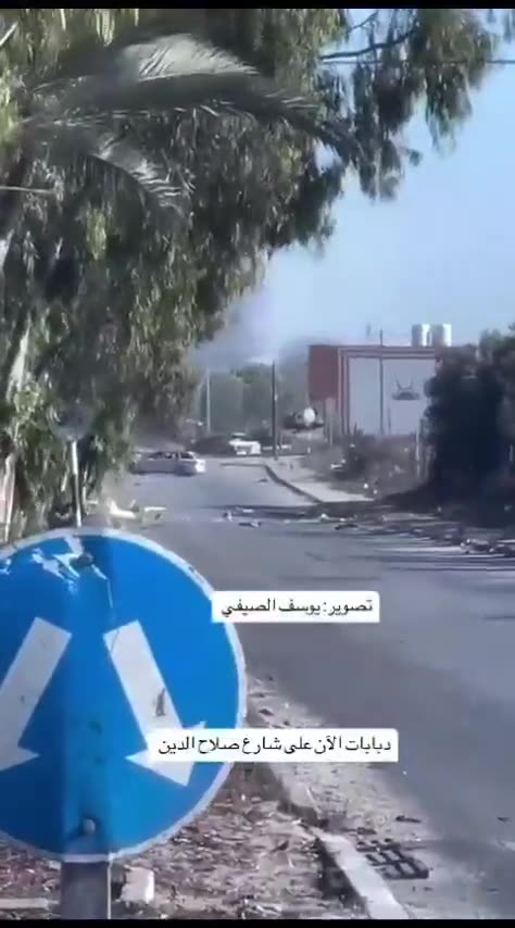 An Israeli tank fires at a civilian vehicle