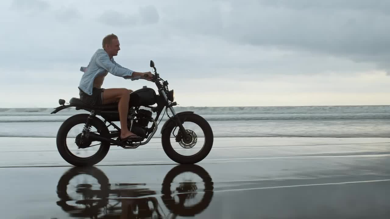 Happy wanderlust riding a motorcycle at the beach