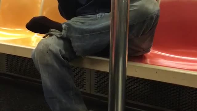 Guy smelling and spraying water product onto shoe