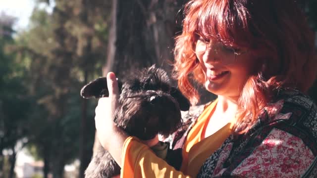 A Woman Petting Her Dog