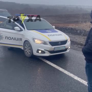Police of Ukraine escort a group of luxury cars towards the border