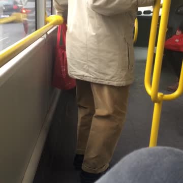 Man bends legs on subway train