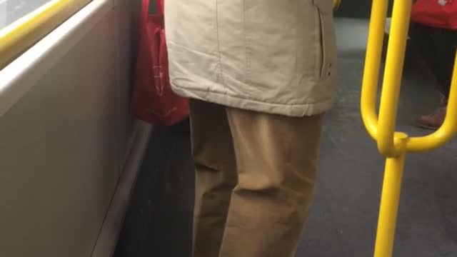 Man bends legs on subway train