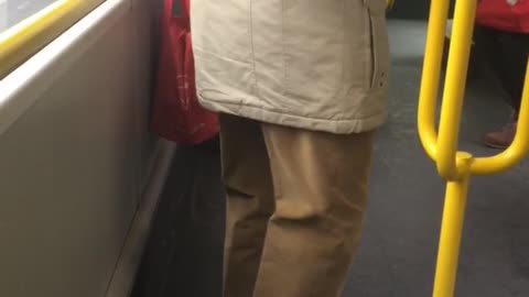 Man bends legs on subway train