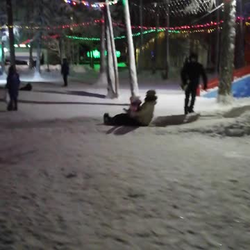 People ride on a winter hill.