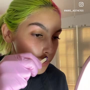 @nanis__aesthetics waxes upper lip with Sexy Smooth Purple Seduction Hard wax