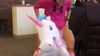 Kid dressed as pink princess on unicorn