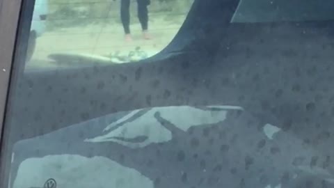 Shirtless man plays with black stick