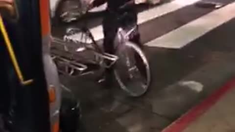 Man with bike argues with bus driver