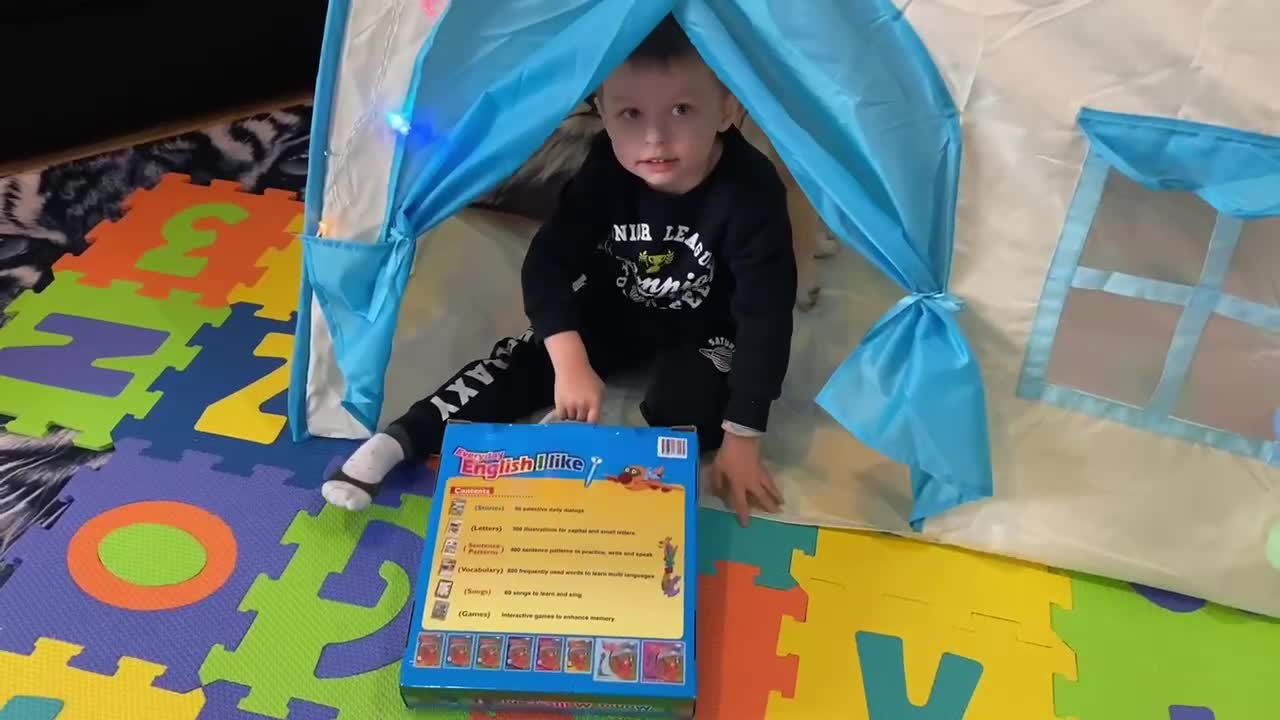 Baby and his dog playing together