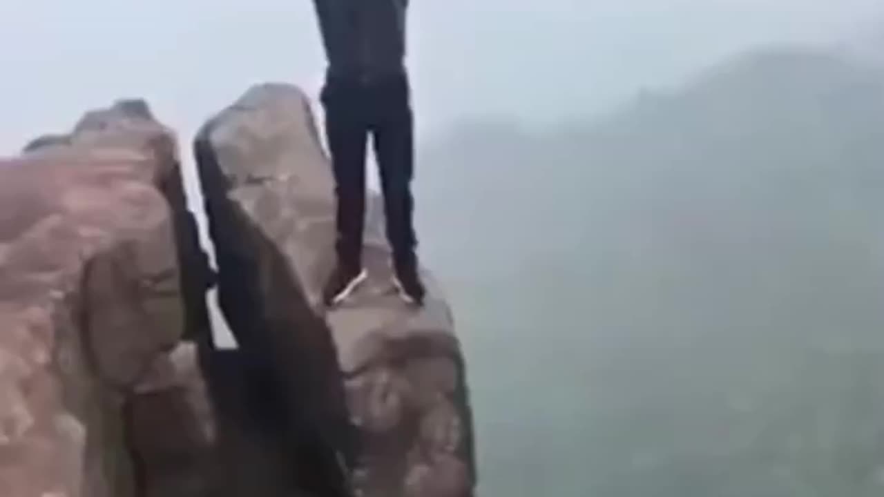 Balancing On Cliff Boulder