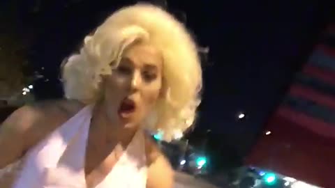 Nsfw guy walking down the street dressed as marilyn monroe