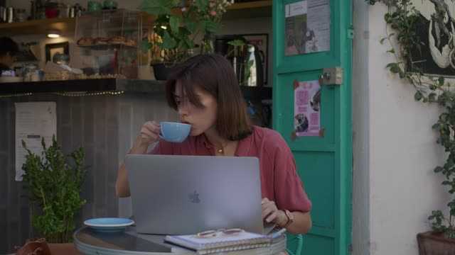 Young woman drinking coffee and working