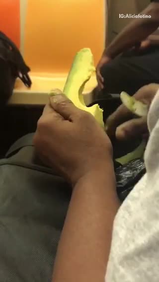 Person peeling an avocado train subway