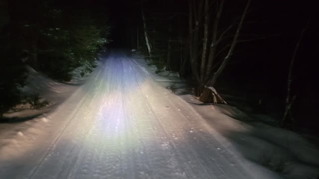 Snowmobile trail grooming in the national forest.