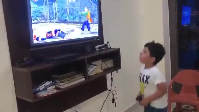 funny little kid playing PS with all his heart