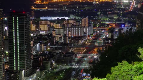 Illuminated city with fast traffic at night