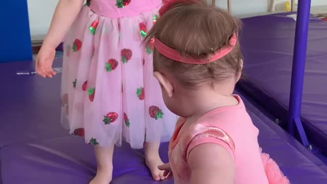 Sweet sister wants to help baby sister who is stuck but determines “it’s” (she’s) too heavy