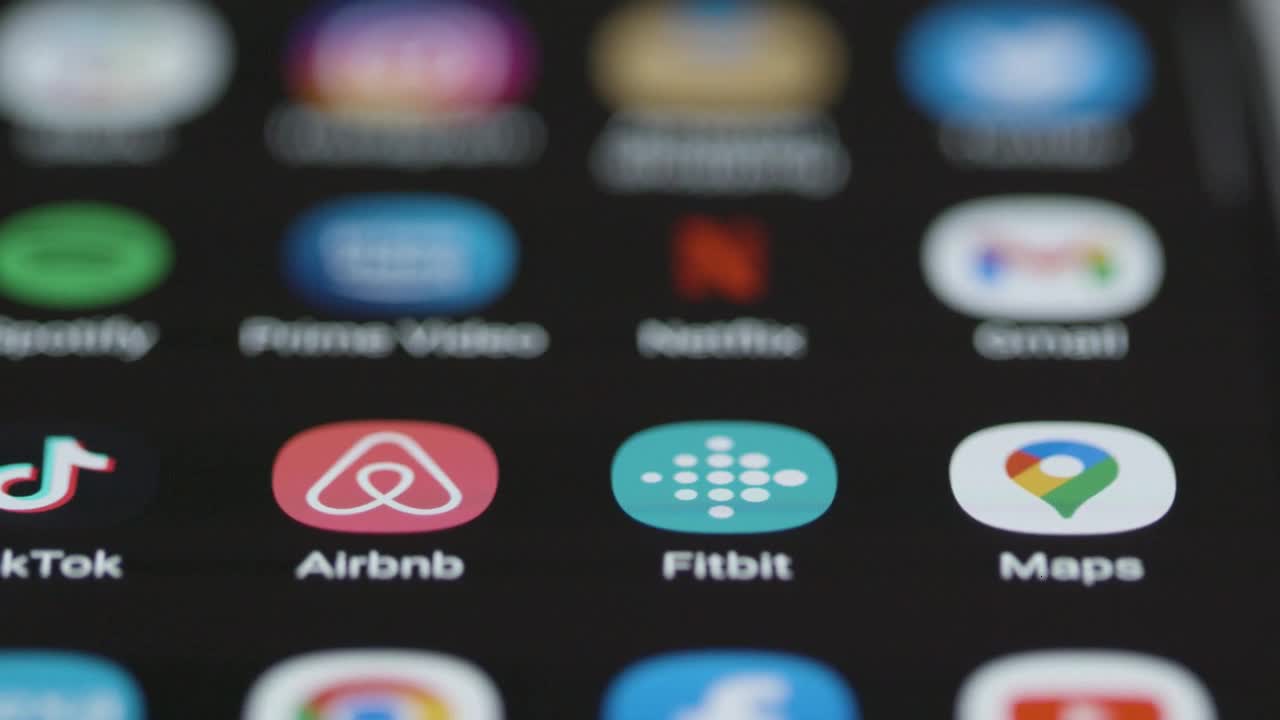 Close Up Orbiting of Fitbit App on Phone
