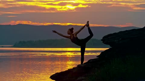 Woman Doing Stretching Exercise By The Lake Side