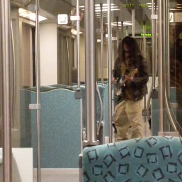Cachi pants guy plays white guitar on long bus