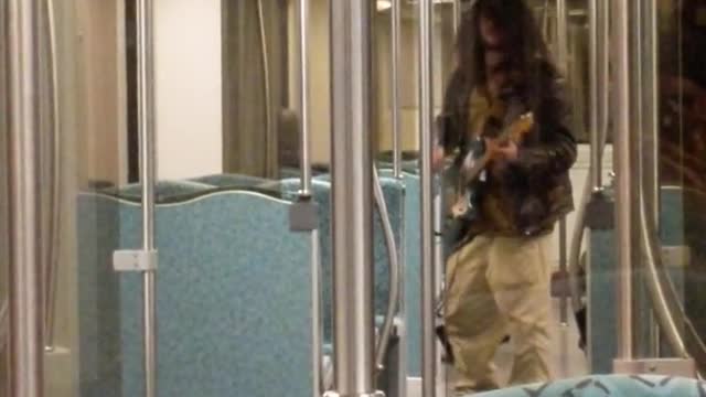 Cachi pants guy plays white guitar on long bus