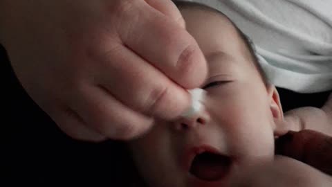 Baby tries to lick the wipe.