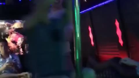 Guy spinning on pole party bus