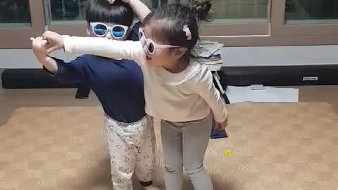 The children are wearing sunglasses and playing.