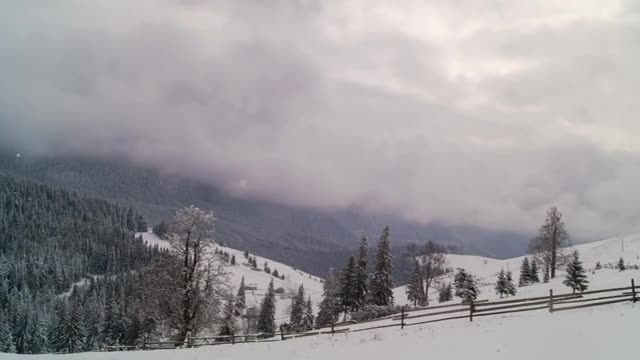 winter mountain with fence and cloudy sky