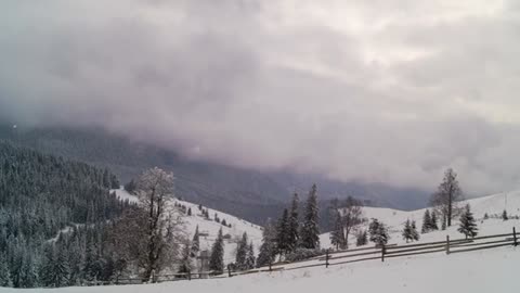 winter mountain with fence and cloudy sky