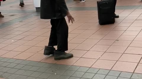 Old man dancing to music subway station