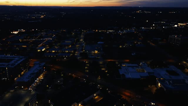 Flying over a city at dusk