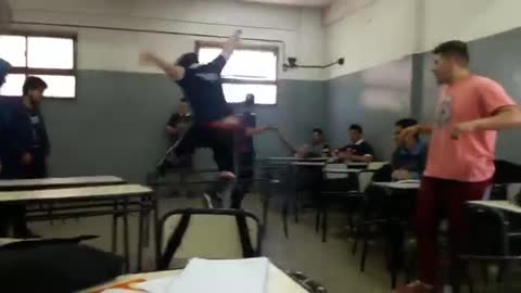 Foreign classroom guy jumps desk