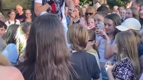 Young man gets on stage with the local rock band to jam to Guns and Roses.